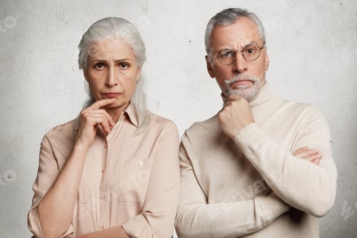 Preview: Two female and male pensioners keep hands on chin, look thoughtfully, watch news, spend time in dome