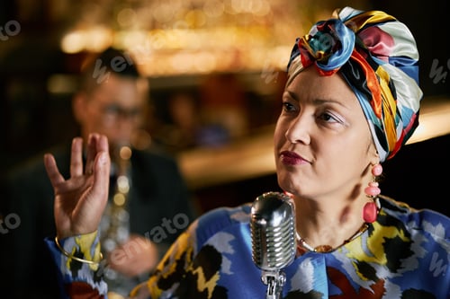 Preview: Multiethnic Elegant Female Singer in Headwrap Performing Jazz Music Indoors