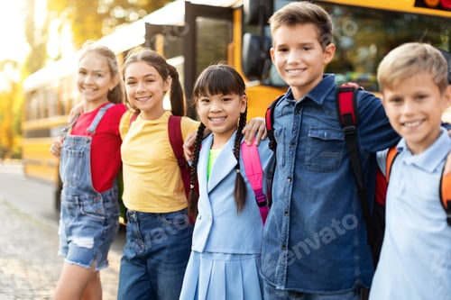 Preview: Cheerful kids ready to board school bus, standing outdoors