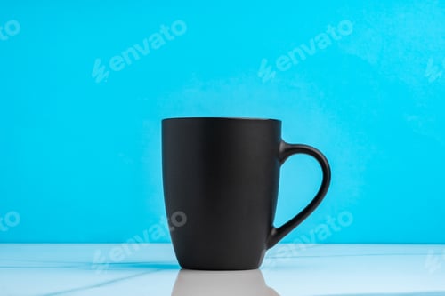 Preview: Ceramic mug on blue studio background close up