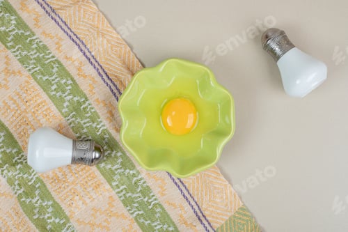 Preview: Uncooked egg in green plate with salt and pepper