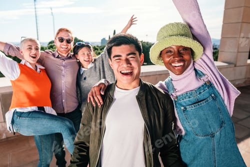 Preview: multiracial couple smiling in front of the camera with three friends smiling and posing