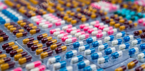 Preview: Selective focus on colorful antibiotic capsule pills in blister pack. Antibiotic drug resistance.
