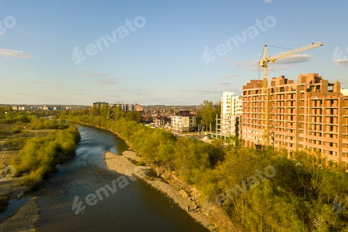 Preview: Aerial view of tall residential apartment buildings under construction and Bystrytsia river in Ivano