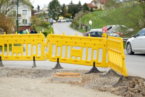 Preview: A plastic yellow barrier fence on the street. Road works