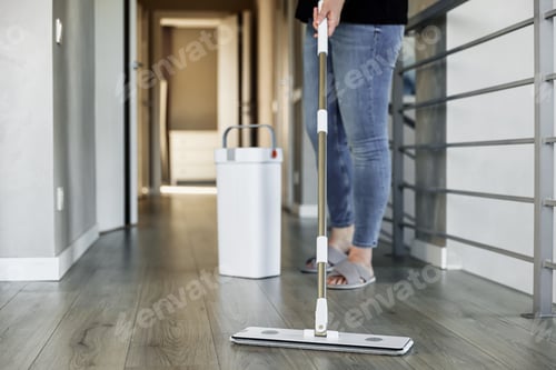 Preview: Woman mopping, wiping floor in home setting. Housewife uses mop, plastic bucket
