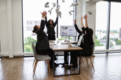 Preview: Business team celebrates success by throwing money in office