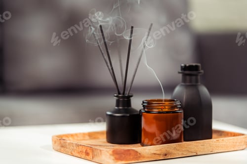 Preview: Aromatic reed freshener and candle on table in room