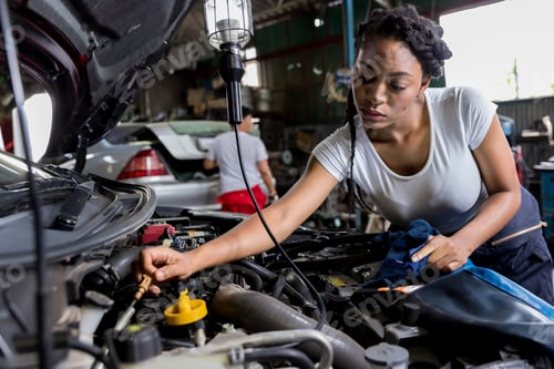 Preview: Car mechanic checking oil quality the engine motor car Transmission and Maintenance Gear.