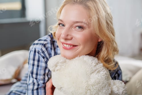 Preview: Close Up Portrait Of Playful Girl Hugging Soft Toy. She Is Looking At Camera And Smiling
