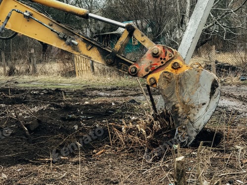 Preview: Excavator uprooting trees on land in countryside