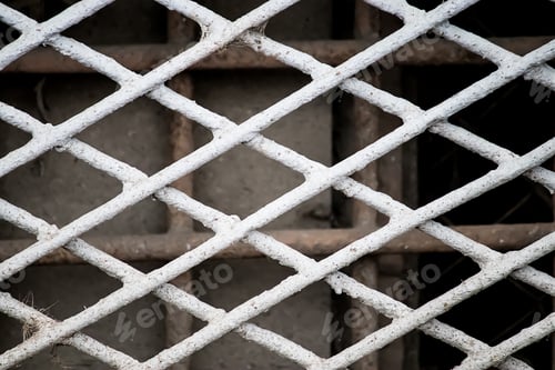 Preview: Old metal grate in basement of abandoned building. Texture of iron fence.