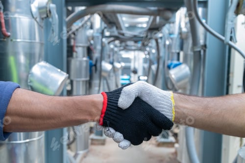 Preview: Engineers Collaborating and Smiling in Industrial Setting