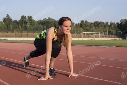 Preview: Sporty female doing a workout in a park - sport and healthy lifestyle concept