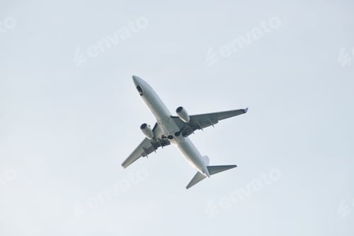 Preview: An airplane seen from below against a cloudless sky