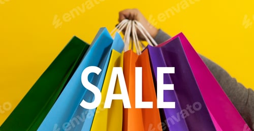 Preview: Sale text. Close-up of a woman's hands holding colorful shopping bags. Copy space. Shopping Concept