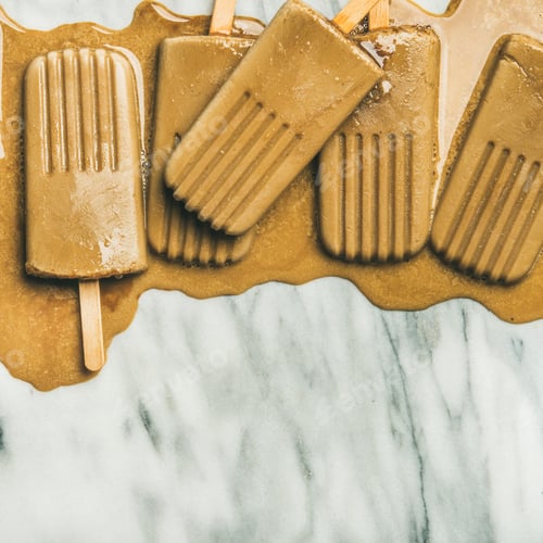 Preview: Flatlay of melting coffee latte popsicles, square crop