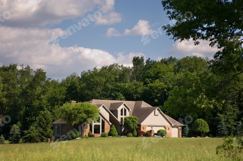 Preview: House with a garden surrounded by bushes and trees under the sunlight and a blue sky