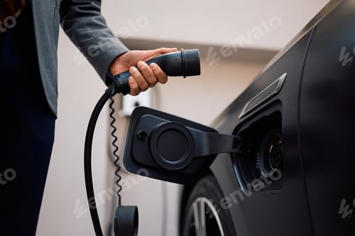 Preview: Close up of man charging power for his electric vehicle.