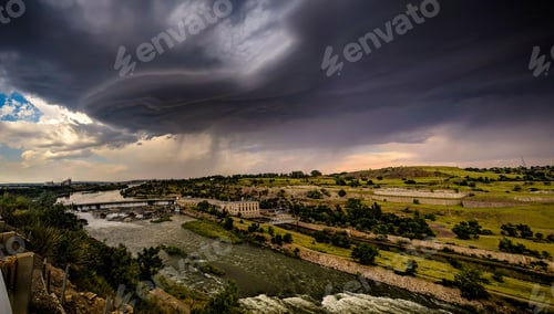 Preview: High-angle shot of a Black Eagle Dam during a thunderstorm with a gloomy and cloudy sky
