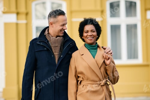 Preview: Portrait of happy couple enjoying during winter day in the city.