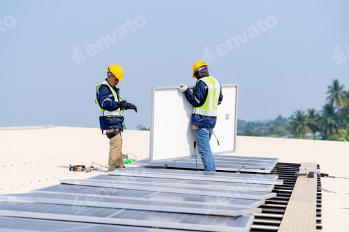 Preview: workers installing solar panels, for efficient energy on rooftop