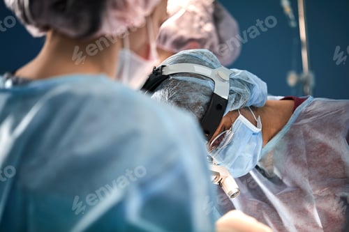 Preview: Surgical team in the operating room, close-up. An international team of professional doctors in a