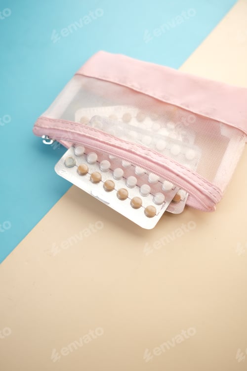 Preview: birth control pills on wooden background, close up