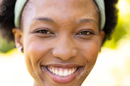 Preview: Closeup portrait of smiling african american mid adult woman in park