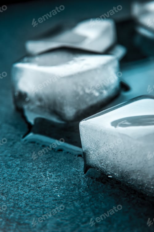 Preview: Ice cubes on the dark stone table vertical