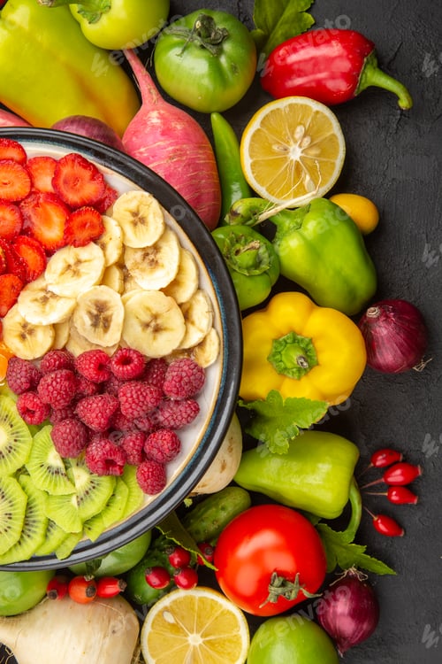 Preview: top view vegetable composition fresh vegetables with sliced fruits on a dark background salad