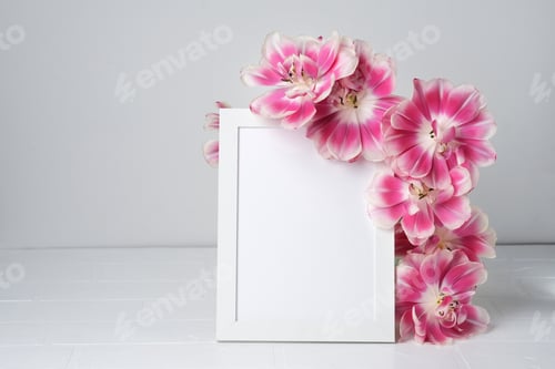 Preview: White Frame Surrounded By Pink Flowers on White Table