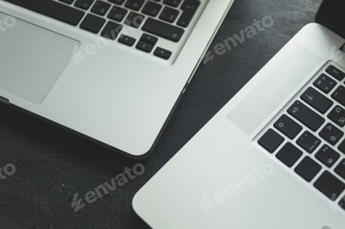 Preview: Two laptops on modern wooden desk