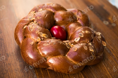 Preview: Tsoureki traditional baked Greek Easter sweet bread, with a boiled red dyed egg in the middle