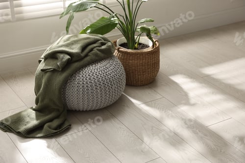 Preview: Stylish knitted pouf with plaid and houseplant at home