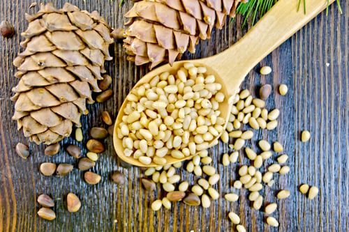 Preview: Cedar nuts refined in spoon on board