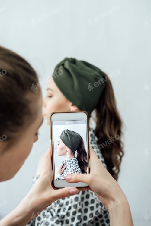 Preview: Women fashion designer taking photo to accessories with cell phone or smartphone digital camera for