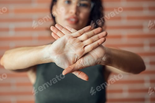 Preview: Woman Showing Hands Crossed in Rejection Stance