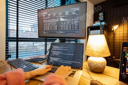 Preview: Female programmer writing programming code at cozy home workplace