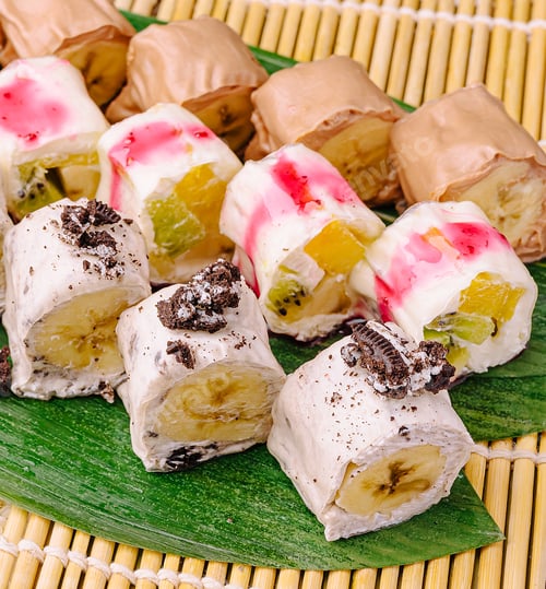 Preview: Delicious dessert rolls are arranged on a bamboo mat