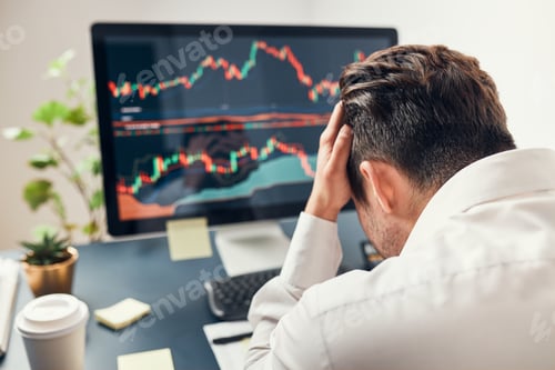Preview: Worried businessman looking at charts stressed by news from stock market. Investor lost money online
