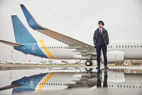 Preview: Portrait of happy confident caucasian airplane crew near plane
