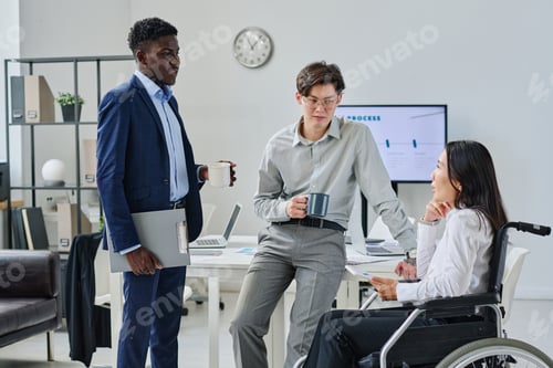 Preview: Colleagues discussing work at office