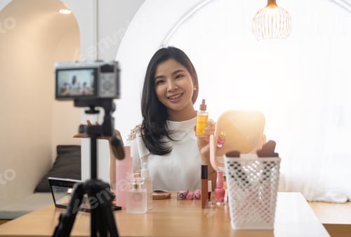 Preview: Young beautiful Asian woman and professional beauty make up artist vlogger or blogger recording