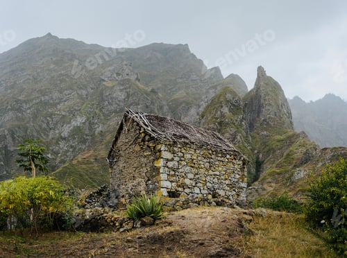 Preview: Ruined local storehouse nestled into incredible scenery with steep mountain rocks and vertical peaks
