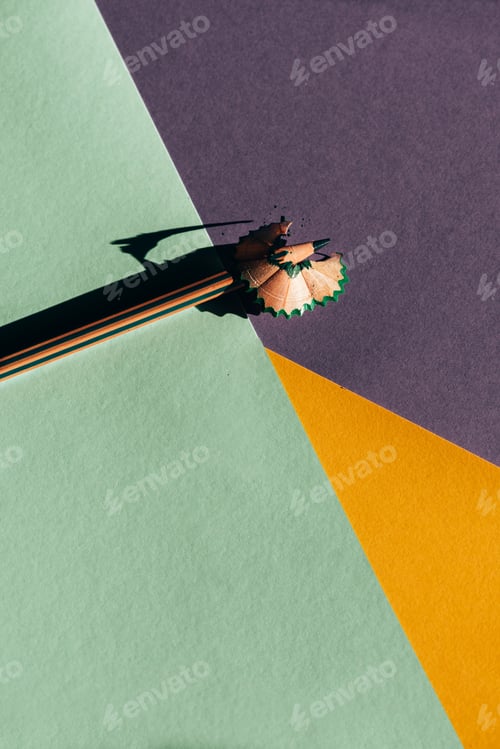 Preview: Pencil and shavings from sharpening, on colored papers backgroun