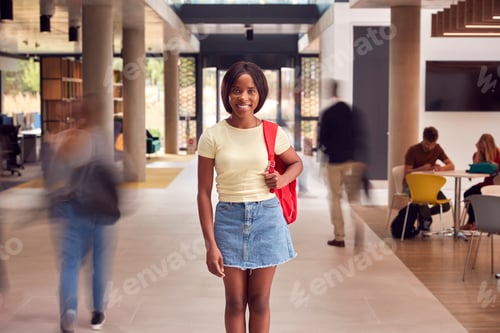 Preview: Portrait Of Smiling Female Student In Busy University Or College Building