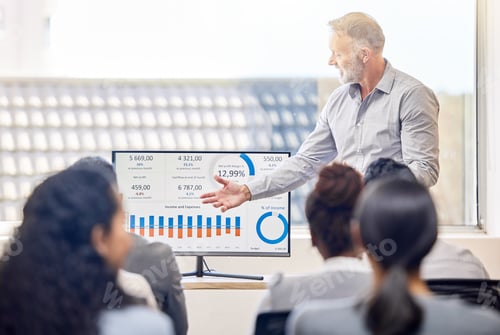 Preview: Cropped shot of a handsome mature businessman giving a presentation in the conference room