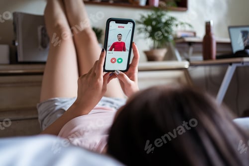 Preview: Asian female browsing dating app on bed