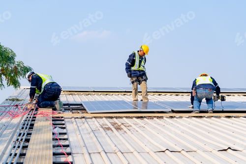 Preview: workers installing solar panels, for efficient energy on rooftop